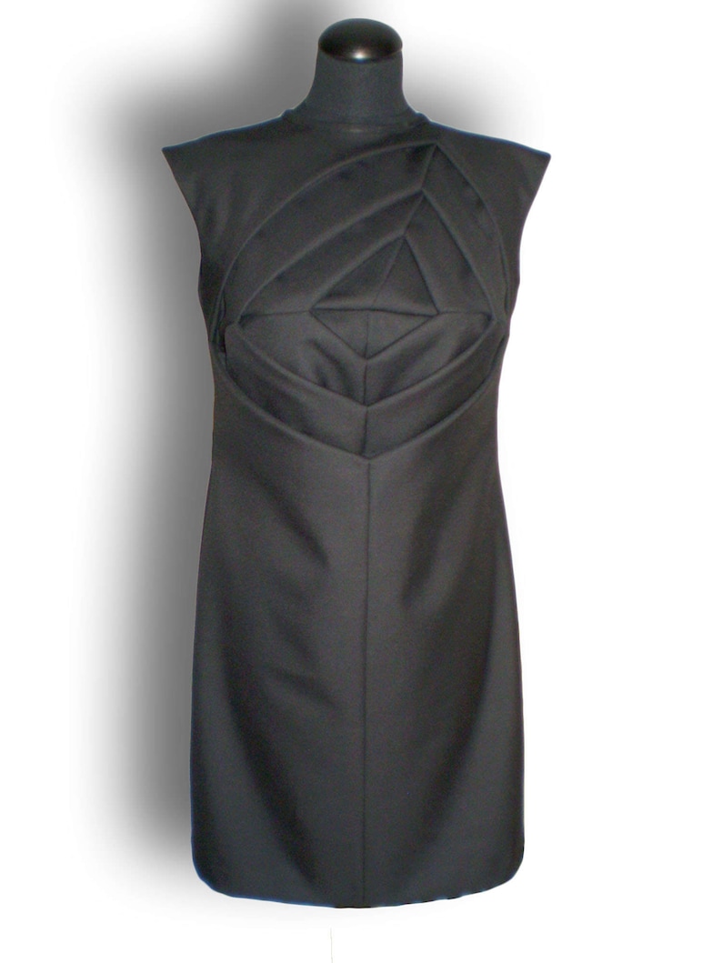 May include: A black sleeveless dress with a geometric design on the bodice.