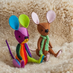 May include: Two felt mouse toys. One is brown with a green scarf and pink ears. The other is multi-coloured with a rainbow pattern and blue ears.