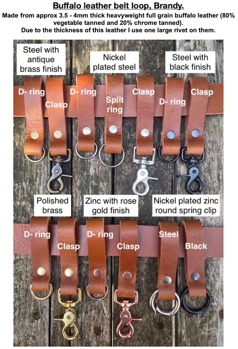 May include: A collection of brandy-coloured buffalo leather belt loops, each secured with a single large rivet. The loops feature various metal hardware attachments including D-rings, split rings, clasps, and spring clips in brass, nickel, steel, and rose gold finishes.