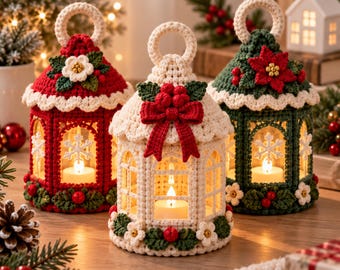 May include: Three crocheted lantern covers in red, cream, and green, each featuring a circular top handle, arched window cutouts with white snowflake accents, and decorative floral embellishments including poinsettias, berries, and bows.