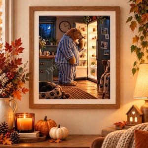 May include: A framed wall art print depicting a brown bear wearing blue and white striped pajamas, standing in a kitchen and looking into an open, illuminated refrigerator. The scene includes a window with a crescent moon and a wall clock.