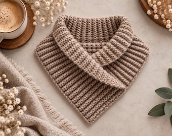 May include: A light brown, triangular-shaped neck warmer featuring a textured, ribbed crochet pattern. The accessory has a folded collar design and is crafted from a soft, knit yarn, displaying a consistent, uniform stitch throughout the piece.