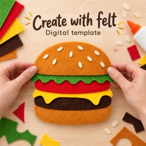 May include: A felt hamburger craft project featuring stacked layers of brown, yellow, red, and green felt pieces. The text "Create with felt Digital template" is printed above the burger, surrounded by loose felt scraps and glue.