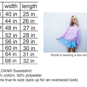 May include: Size chart for a Gildan sweatshirt, showing width and length measurements in inches for sizes small through 5XL. The chart notes that the sweatshirt is made of 50% cotton and 50% polyester and runs true to size. A model is wearing a size small.