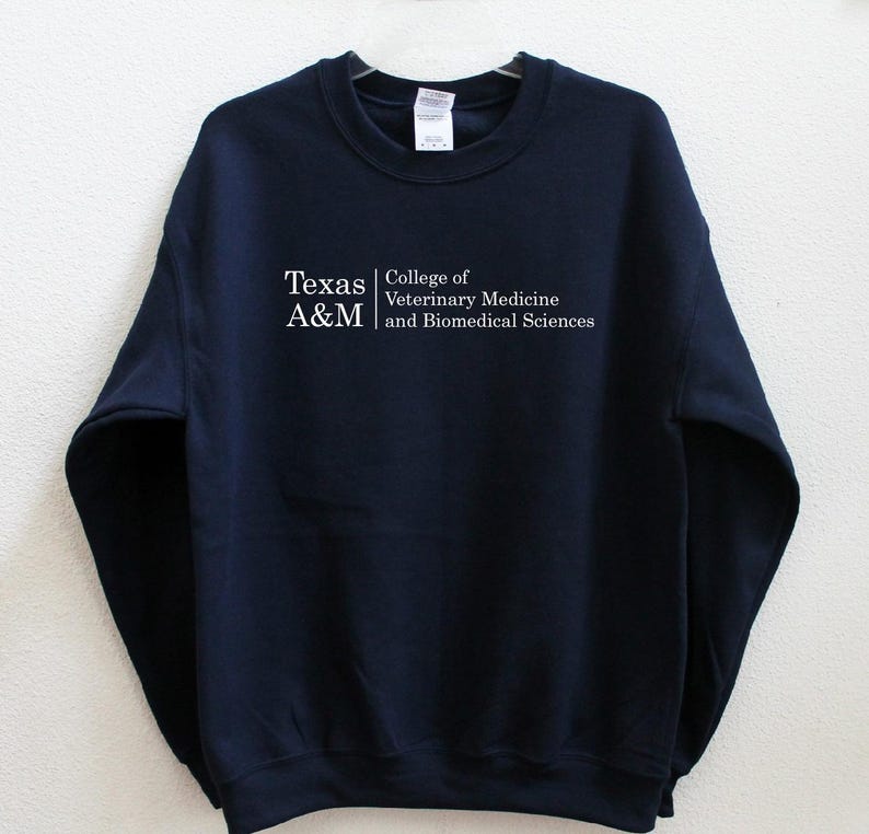 May include: A navy blue sweatshirt with the text "Texas A&M College of Veterinary Medicine and Biomedical Sciences" printed in white on the front.