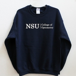 May include: Navy blue sweatshirt with white text that reads "NSU College of Optometry".