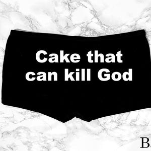May include: Black boxer briefs with the text "Cake that can kill God" in white. The word "Back" is printed in white at the bottom right corner. The background is a marble pattern.