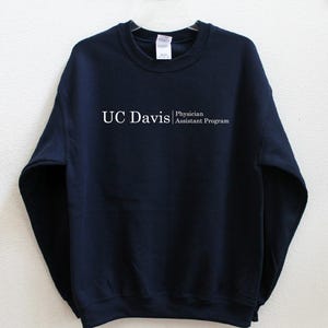 May include: Navy blue sweatshirt with the text "UC Davis Physician Assistant Program" printed in white on the front.
