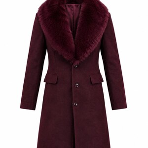 May include: A deep burgundy coat featuring a large, plush faux fur collar in a matching shade. The coat has long sleeves, a structured silhouette, and a front button closure with three visible buttons and two side flap pockets on the front.