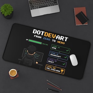 May include: A black rectangular desk mat featuring a pixel art design with the text DOTDEVART FROM ZERO TO HERO. The graphic includes a progress bar, a character at a computer, and a list of levels labeled HTML, JAVASCRIPT, REACT, and FULL STACK HERO.