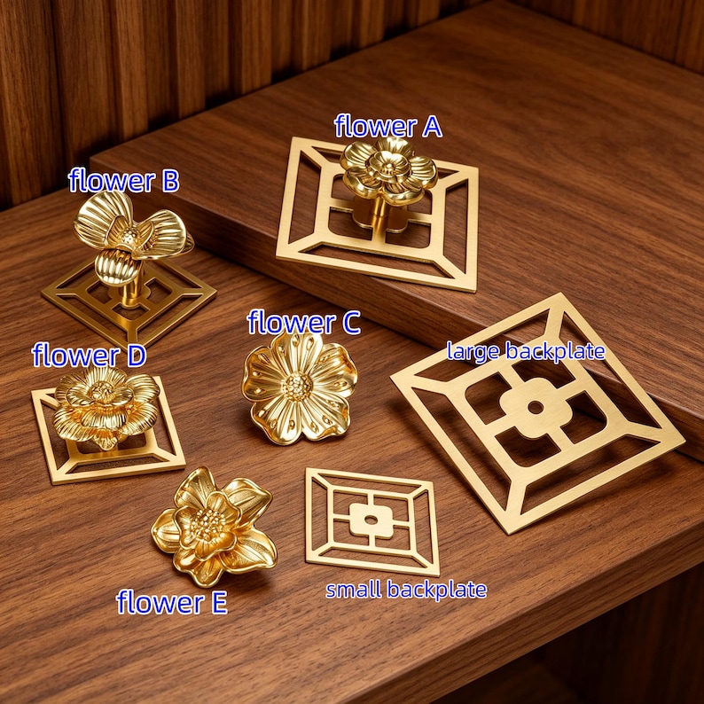 May include: A collection of gold-toned metal cabinet knobs and backplates. The set includes flower A, flower B, flower C, flower D, and flower E designs, along with a large backplate and a small backplate, each featuring geometric cutouts.