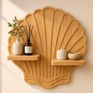 May include: A light brown wooden wall shelf shaped like a large seashell with vertical carved ridges. Two small horizontal shelves are attached to the front. The left shelf holds a white vase with greenery and a brown glass reed diffuser bottle.