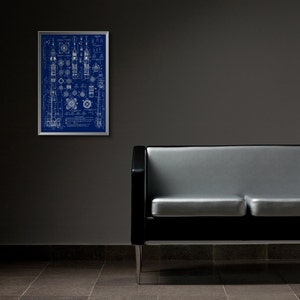 May include: A black and silver two-seater sofa with a blueprint design framed on the wall behind it.