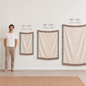 Three rectangular woven throw blankets in cream with multicolored fringed edges, displayed in sizes 52 by 37 inches, 60 by 50 inches, and 80 by 60 inches, shown alongside a person for scale to demonstrate the varying dimensions.