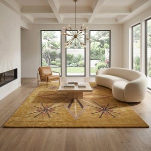 May include: A large rectangular area rug in a deep mustard yellow hue featuring a central geometric diamond motif and radiating starburst patterns in shades of brown and tan, crafted with a textured pile that covers the wooden floor space.