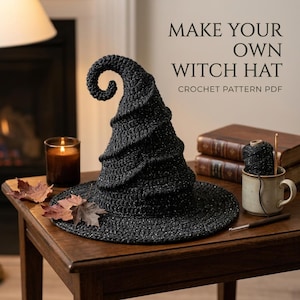Puede incluir: Un sombrero de bruja negro tejido a ganchillo con una punta curvada y un sutil brillo metálico. El texto MAKE YOUR OWN WITCH HAT CROCHET PATTERN PDF es visible. El sombrero presenta un ala ancha y un diseño texturizado en espiral.