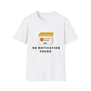May include: A white short-sleeve t-shirt featuring a graphic of stacked computer windows with a red circle containing an X, the text SYSTEM ERROR, and a teal OK button. Below the graphic, the text NO MOTIVATION FOUND is printed in black.