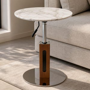 May include: A round side table with a white marble top featuring grey veining. The table has an adjustable height mechanism with a black handle, a central wooden post with a vertical cutout, and a circular polished chrome base for stability.