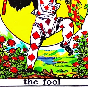 May include: Tarot card illustration of a monkey-like figure in a jester's outfit, holding a staff and a scarf. The figure is set against a yellow background with a floral border and the text "the fool" at the bottom.
