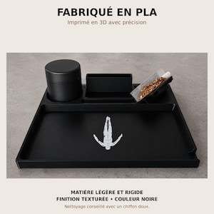 May include: A black 3D-printed PLA organizer tray featuring a cylindrical container, a rectangular compartment, and a slot holding a small bag of loose material. The tray surface displays a white graphic of a human figure in a diving pose.