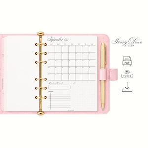 May include: A light pink six-ring binder planner featuring a gold metal mechanism and a gold pen. The open page displays a September calendar grid, a section for affirmation of the month, a priorities list, and a dotted notes area. Text includes Ivory Dove Studio.