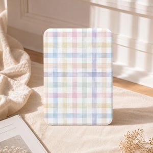 May include: A rectangular tablet case featuring a soft watercolor plaid pattern in pastel shades of pink, blue, yellow, and purple. The design consists of intersecting horizontal and vertical stripes creating a grid effect across the entire surface.