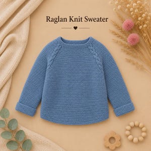 May include: A blue long-sleeve raglan knit jumper featuring a textured garter stitch pattern and cable knit details along the raglan seams. The jumper has a round neckline and folded cuffs at the ends of the sleeves. The text Raglan Knit Sweater is visible.