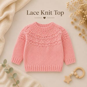 May include: A long-sleeve knit jumper in a soft pink colour featuring a round neckline and a decorative lace-like stitch pattern across the yoke. The garment has ribbed cuffs and a ribbed hem. The text "Lace Knit Top" is printed above the jumper.