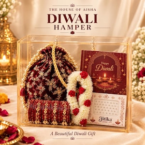 May include: A clear acrylic box containing a maroon velvet drawstring pouch with gold embroidery, a set of maroon bangles with gold accents, a white floral garland with red roses, and a card labeled Happy Diwali and Jitika Bindi.