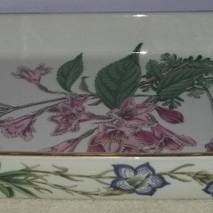 May include: White ceramic baking dish with a gold rim and a floral design featuring pink and green flowers.