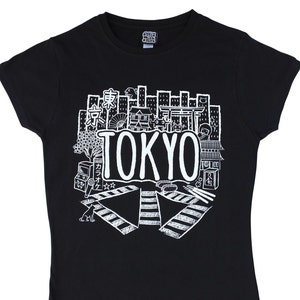 May include: Black t-shirt with a white graphic design of a cityscape with the word "TOKYO" in large letters. The graphic includes various Japanese symbols and illustrations.