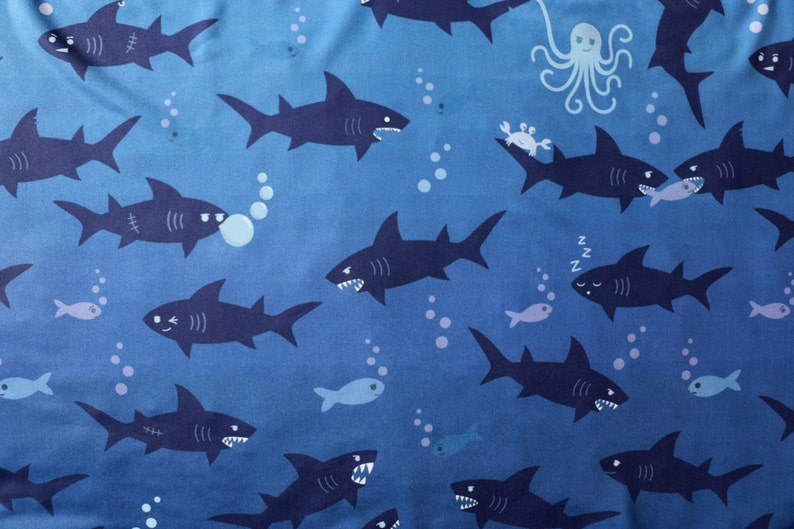 Shark pattern in blue, with fun, quirky details of sharks getting up to mischief.