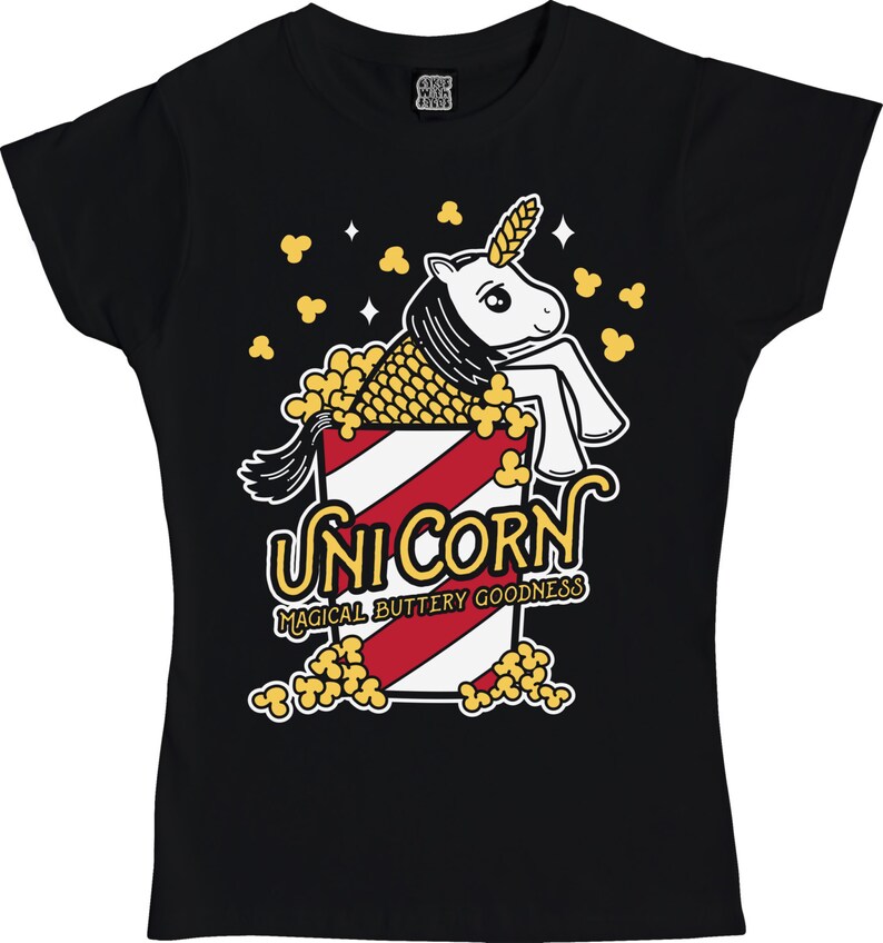 May include: Black t-shirt with a white unicorn inside a red and white striped popcorn bucket. The unicorn has a yellow mane and tail. The text "Unicorn Magical Buttery Goodness" is printed below the bucket.