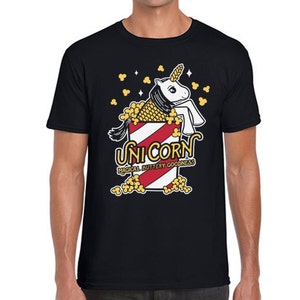May include: Black t-shirt with a white unicorn in a red and white striped popcorn bucket. The text "Unicorn" is above the bucket and "Magical Buttery Goodness" is below the bucket.