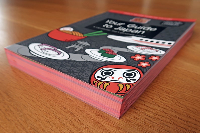 Japan travel guide book with red page edges.