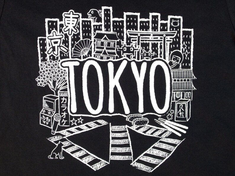 May include: Black and white illustration of a cityscape with the word "TOKYO" in a large, bold font. The illustration includes buildings, a cherry blossom tree, a karaoke machine, a cat, and a traditional Japanese gate.