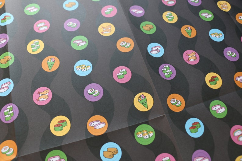 May include: A black background with colourful circles featuring different types of sushi. The circles are arranged in a wavy pattern.