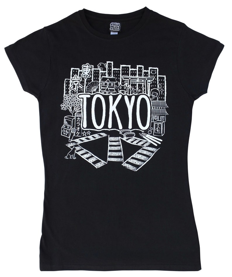 May include: Black t-shirt with a white graphic design of a cityscape with the word "TOKYO" in large letters. The graphic includes various Japanese symbols and illustrations.