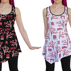 May include: Two sleeveless dresses with a Japanese cherry blossom and temple print. One dress is black with white flowers and the other is white with pink flowers.