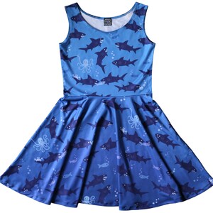 Sleeveless skater dress (just above knee length) in blue with a pattern of sharks.