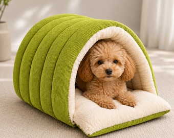 May include: A lime green corduroy pet bed shaped like a tunnel or cave with a soft cream-colored sherpa fleece interior lining and a matching removable cushion base, featuring a small light brown curly-haired dog resting inside.