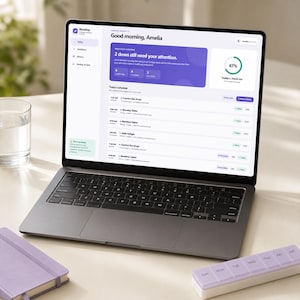 May include: A dark gray laptop displaying the DoseDay medication tracking interface. The screen shows a daily schedule, a 67% check-in progress circle, and a notification stating 2 doses need attention. A purple pill organizer sits nearby.