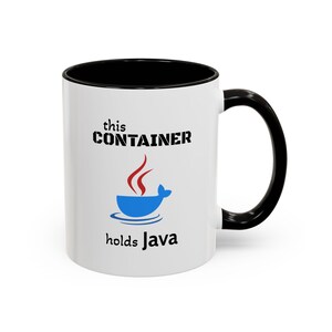 May include: A white ceramic mug with a black interior and handle. The front features the text this CONTAINER in black, a blue whale-shaped bowl graphic with red steam, and the text holds Java in black below the graphic.