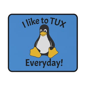 May include: A rectangular mouse pad with a blue background and a black border. The center features a graphic of a black and white penguin with yellow feet and a yellow beak. The text "I like to TUX" appears above the penguin and "Everyday!" below.