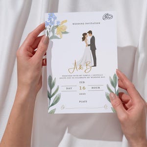 Puede incluir: Una tarjeta de invitación de boda blanca con una ilustración en acuarela de una pareja, flores azules y amarillas, y hojas verdes. El texto dice WEDDING INVITATION, A & B, TOGETHER WITH MY FAMILY, I JOYFULLY INVITE YOU TO CELEBRATE MY WEDDING DAY, FEB 16 2025.