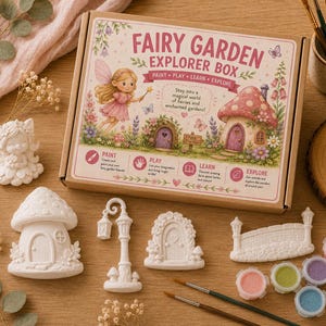 May include: A Fairy Garden Explorer Box kit featuring a cardboard box with fairy illustrations and text, including white ceramic figures of a mushroom house, a lamp post, a door, and a bridge, plus small paint pots and two paintbrushes.