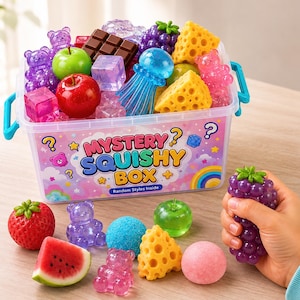 May include: A clear plastic storage container labeled Mystery Squishy Box filled with various colorful squishy toys including miniature fruits, gummy bears, cheese wedges, and a blue jellyfish. Several loose squishy items are arranged in front of the box.