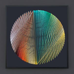 May include: A square framed wall art piece featuring a circular string art design. The composition uses a gradient of colored threads, transitioning from warm orange and red tones on the left to cool teal, green, and yellow hues on the right.