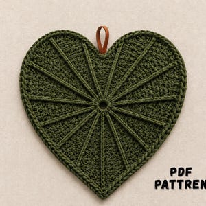 May include: A heart-shaped crochet potholder in dark olive green with a radiating sunburst stitch pattern and a small brown leather hanging loop at the top. The text PDF PATTREN is printed in black in the bottom right corner of the image.