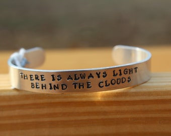 Little Women - "There is always light behind the clouds." Metal stamped literary quote aluminum cuff bracelet - Louisa May Alcott